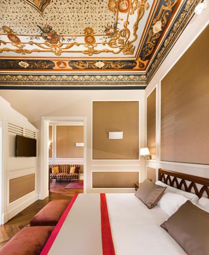 a bedroom with a bed and a coffered ceiling at Catalonia Las Cortes in Madrid