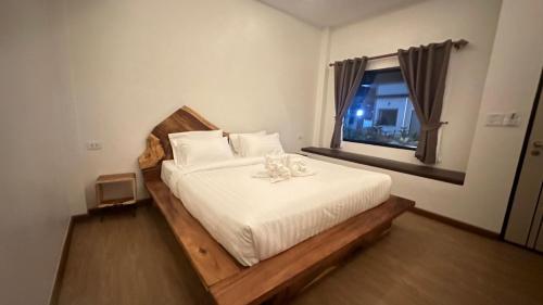 ein Schlafzimmer mit einem Bett mit einer Blume darauf in der Unterkunft บ้านโอบอ้อม in That Phanom