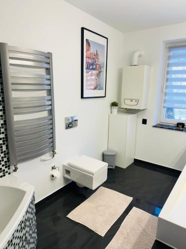a white bathroom with a sink and a toilet at Villa Vincentów in Myślenice