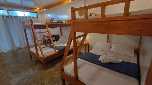 a bedroom with two bunk beds and a ladder at RGL Place Siargao in General Luna
