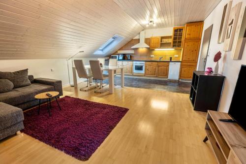 a living room with a couch and a table at Ferienwohnungen Haus Birgit in Günzgen