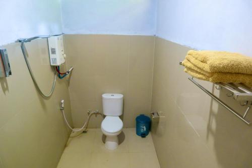 a small bathroom with a toilet in a stall at Tangkoko Homestay in Rinondoran