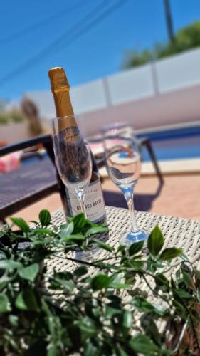 a bottle of wine and a glass on a table at Villa Carpe Diem (Seize the day) in Carvoeiro