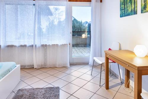 a living room with a table and a window at Ferienwohnungen Haus Birgit in Günzgen
