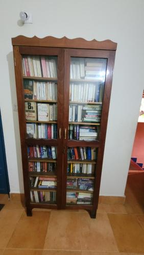 a book cabinet filled with books at Neela House in Kovalam
