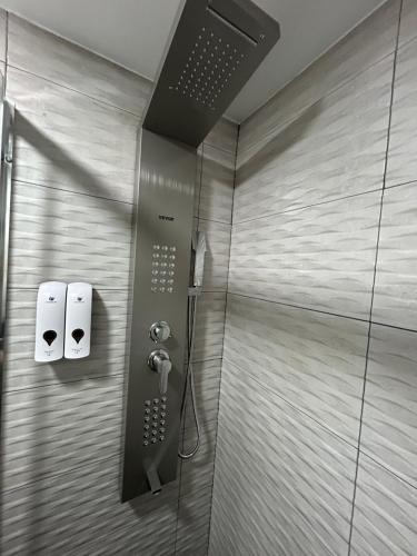 a shower in a bathroom with two rolls of toilet paper at Habitacion con jacuzzi y baño privado in Madrid