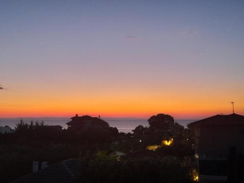 a sunset from the balcony of a house at OASIS VILLA in Litochoro