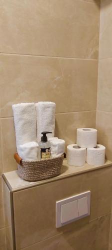un estante con toallas y una cesta de papel higiénico en Apartament Mehmeti, en Ulcinj