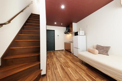 a room with a staircase and a bed and a stair case at 西九条 CHILL - Nishikujo CHILL in Osaka