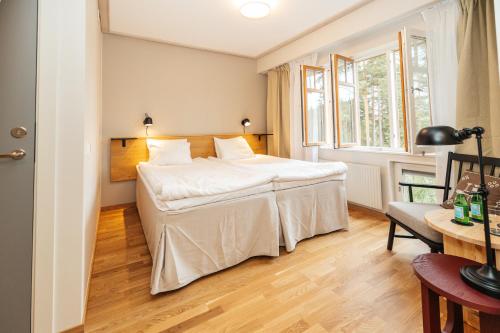 a hotel room with a bed and a window at Barken Lodge in Smedjebacken