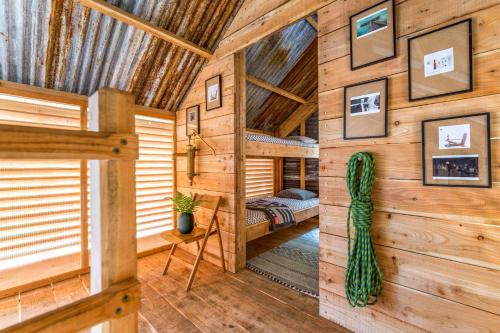 a log cabin with a bedroom and a bed at Architectural Danish Cabin surrounded by nature in Treknow