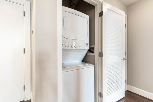 a kitchen with a white refrigerator in a closet at Reston 1br w pool wd close to shopping mall WDC-828 in Reston