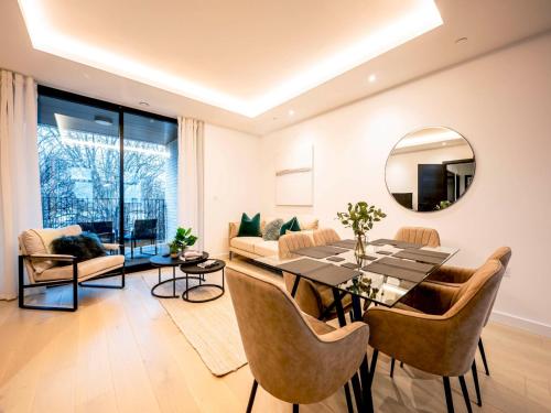 a living room with a dining table and a mirror at Pass the Keys Modern Exuberance and Luxury at Lucent House in London