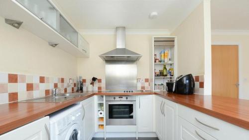 a kitchen with a sink and a stove top oven at Ferry Gait in Edinburgh