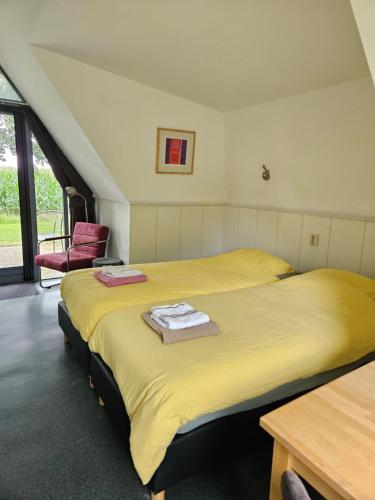 duas camas sentadas uma ao lado da outra num quarto em De Staakenborgh em Bourtange