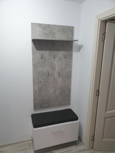a room with a stone wall with a white drawer at Bucovina Cazare in Câmpulung Moldovenesc