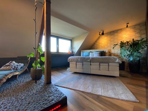 a living room with a bed in a loft at Wellness Suiten mit Whirlpool am Stadtrand von Essen in Essen