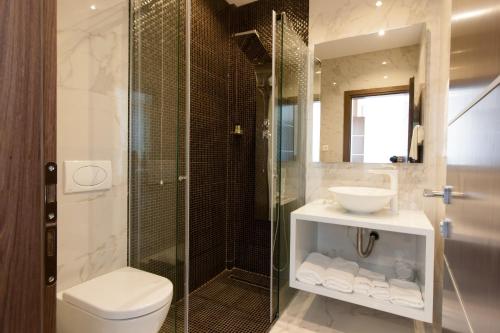 a bathroom with a toilet and a sink and a shower at Perla Luxury in Ulcinj