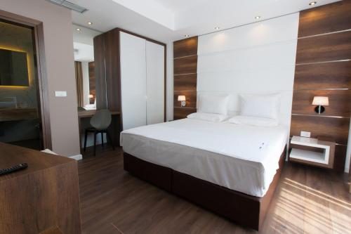a hotel room with a bed and a desk at Perla Luxury in Ulcinj