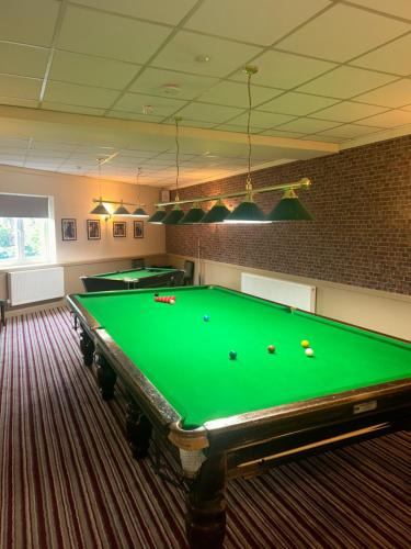 a billiard room with a green pool table at The Cotteridge Inn in Birmingham