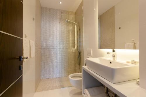 a bathroom with a sink and a toilet and a shower at Perla Luxury in Ulcinj
