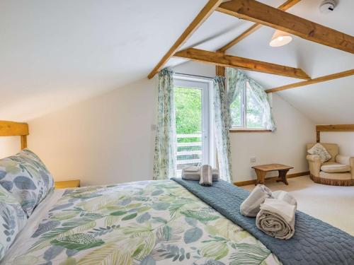 a bedroom with a large bed and a window at 3 Bed in Chulmleigh 87779 in Eggesford