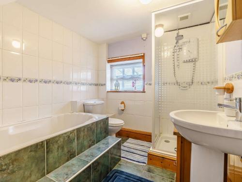 a bathroom with a tub and a sink and a toilet at 2 Bed in Kielder 88214 in Yarrow