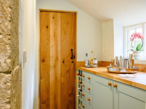 a kitchen with a counter with a wooden door at 3 Bed in Beaminster 87914 in South Perrott