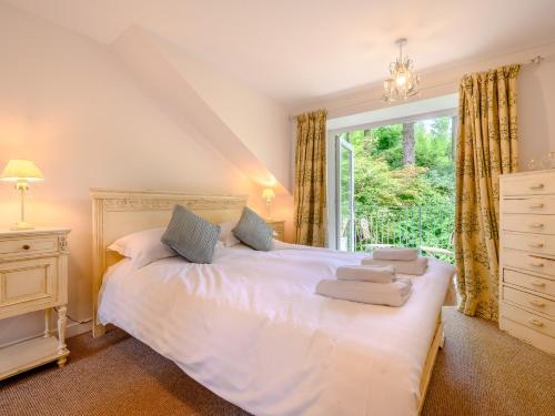 a bedroom with a white bed and a window at 2 Bed in Cunsey 88319 in Far Sawrey