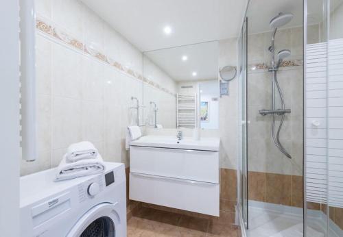 a bathroom with a washing machine and a shower at MY CASA - DELOYE - GUSTAVE - Spacious and Quiet studio with Ac near Old Town in Nice