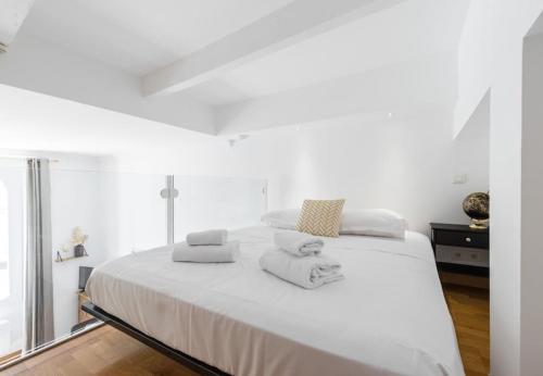 a bedroom with a white bed with towels on it at MY CASA - DELOYE - GUSTAVE - Spacious and Quiet studio with Ac near Old Town in Nice