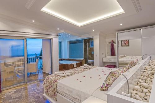 a bedroom with a large bed and a balcony at Villa Mono / Kalkan in Kas