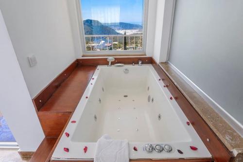 a bath tub in a room with a window at Villa Mono / Kalkan in Kas