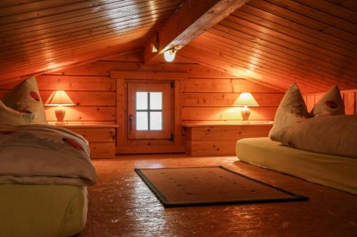 a room with two beds in a log cabin at Haus Cürsgen - Blockhaus Jana in Berlin