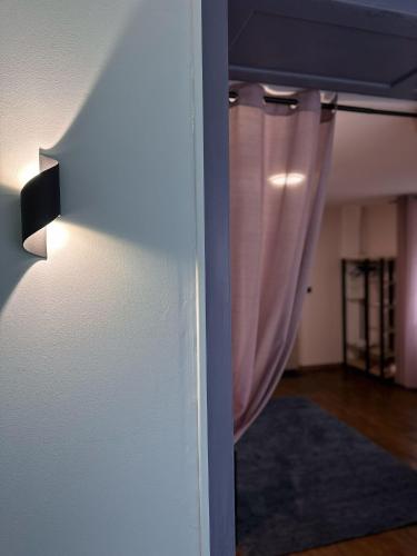 a door with a curtain in a room at Appart O'key in Lure