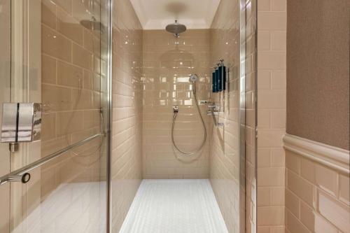 a shower with a glass door in a bathroom at Hilton Grand Vacations Club Craigendarroch Suites Scotland in Ballater