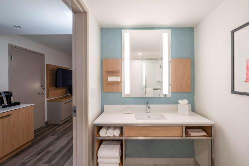 a bathroom with a sink and a mirror at Hilton Garden Inn Ft. Lauderdale Airport-Cruise Port in Dania Beach