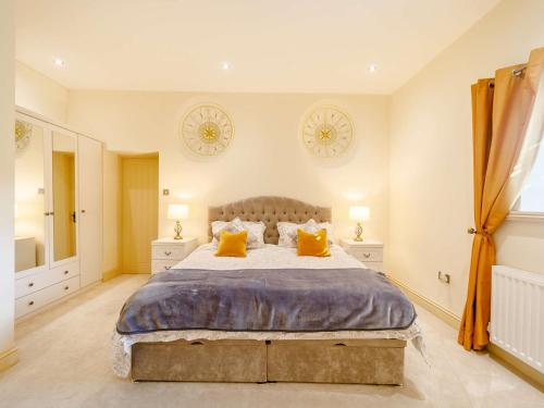 a bedroom with a large bed with yellow pillows at 2 Bed in Rowlands Gill 89758 in Stanley
