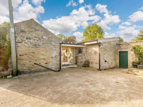 an old brick house with a green door at 2 Bed in Rowlands Gill 89758 in Stanley