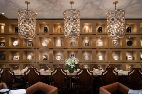 a dining room with a table and chandeliers at Rydges South Bank Brisbane in Brisbane