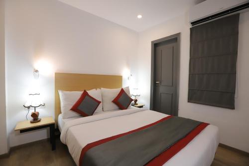 a bedroom with a large bed in a room at Qotel Comfort IP Residency East Delhi Preet Vihar in New Delhi