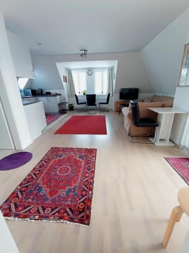 a living room with a rug on a wooden floor at Peaceful Apartment- 3 Zi- Loggia & Garden in Blankenese- in Hamburg