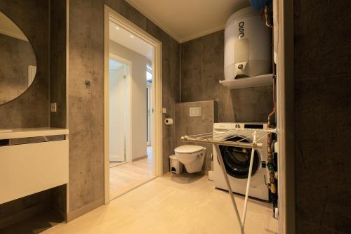 a kitchen with a washer and dryer in a room at Leilighet med utsikt i Loen in Stryn