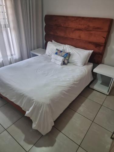 a bed with white sheets and pillows on it at The Blyde Riverwalk Estate in Pretoria