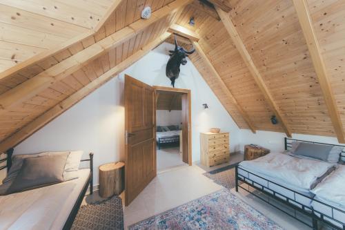 a attic bedroom with a bed and a doorway at Chalupa Lodge in Varvažov