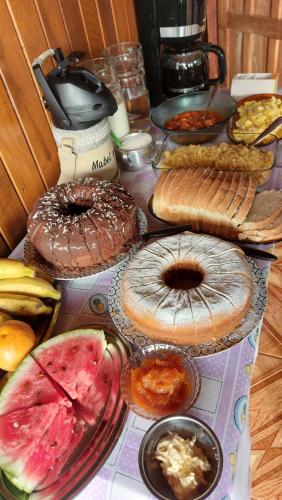 a table topped with lots of different types of bread at Cabañas El Mirador in El Soberbio