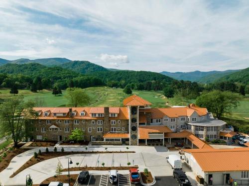 an aerial view of a resort with mountains in the background at Waynesville Inn and Golf Club, Tapestry Collection by Hilton in Waynesville