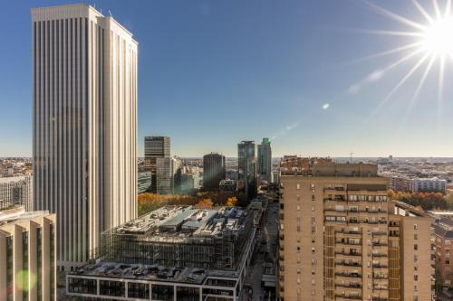 a view of a city with the sun in the sky at Bright with views -2Bd 1Bth- Bernabeu in Madrid