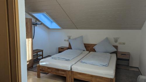 a bedroom with two beds and a skylight at Cafe zum Toni in Thyrnau