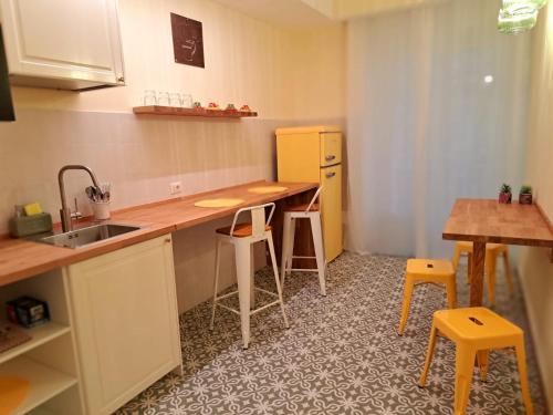 a kitchen with a sink and a table and chairs at Antichi Orefici in Naples